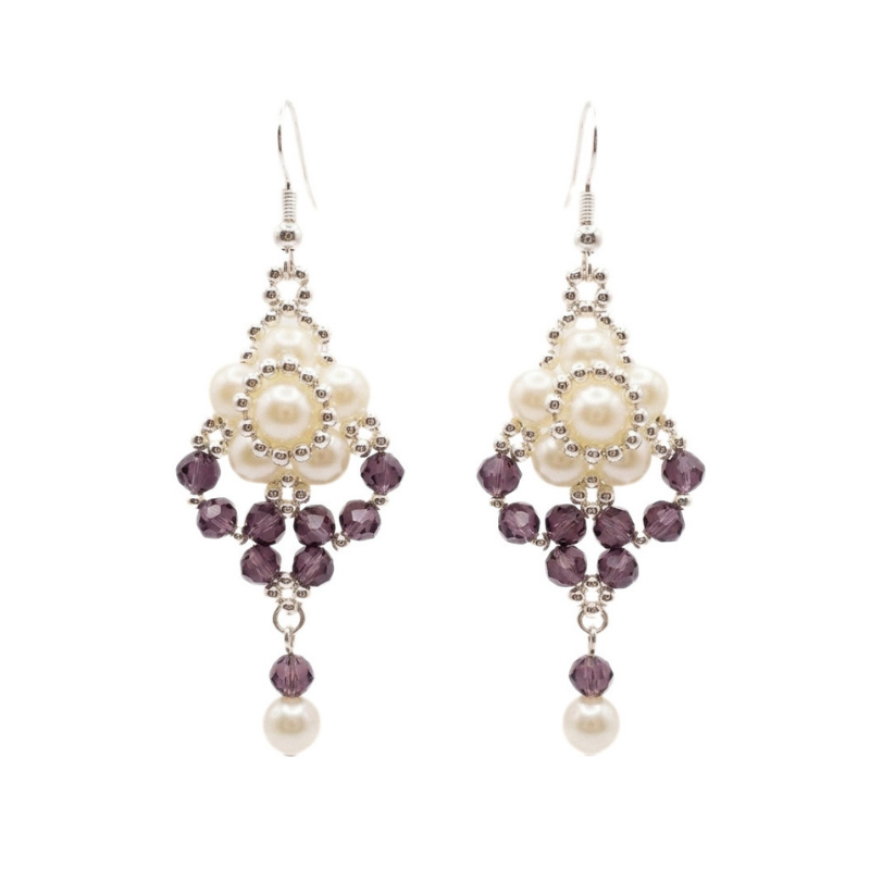 Elegant drop earrings featuring luminous off-white pearls arranged with faceted amethyst purple crystals and silver-toned beads, finished with a dangling purple crystal and pearl on a white background.