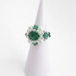 Handmade beaded ring featuring faceted emerald crystals, white pearls, and silver accent beads