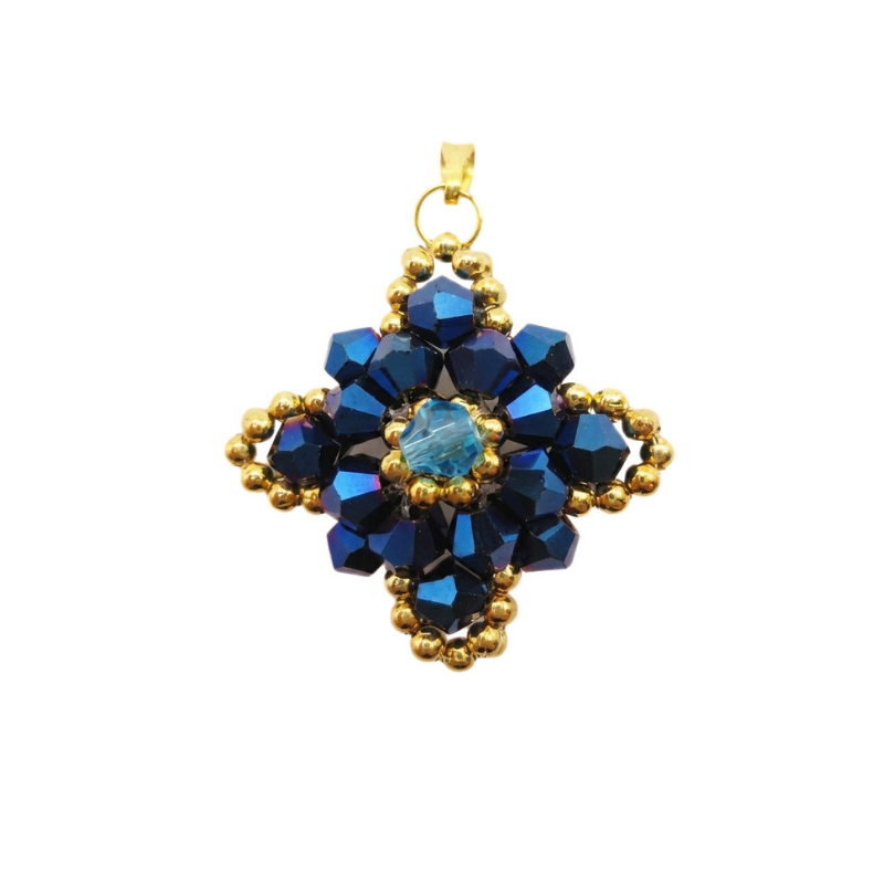 Navy blue crystal pendant with metallic blue crystals, aquamarine-coloured centre crystal, and gold-coloured bead accents. Shown against a white background.