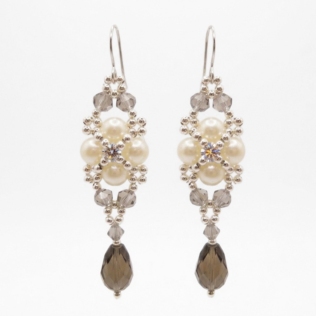 pearl-smokey-crystal-drop-earrings White pearl and smoky grey crystal beaded drop earrings with silver findings, shown against a white background.