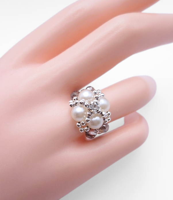 pearl-smoky-crystal-ring-mannequin White pearl and smoky grey crystal beaded statement ring with cubic zirconia centre, displayed on a hand mannequin.