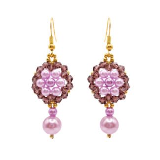 Pair of elegant purple pearl and crystal earrings with luminous lavender pearls, faceted plum-purple crystals, gold-coloured accents and dangling pearl drops on a white background.