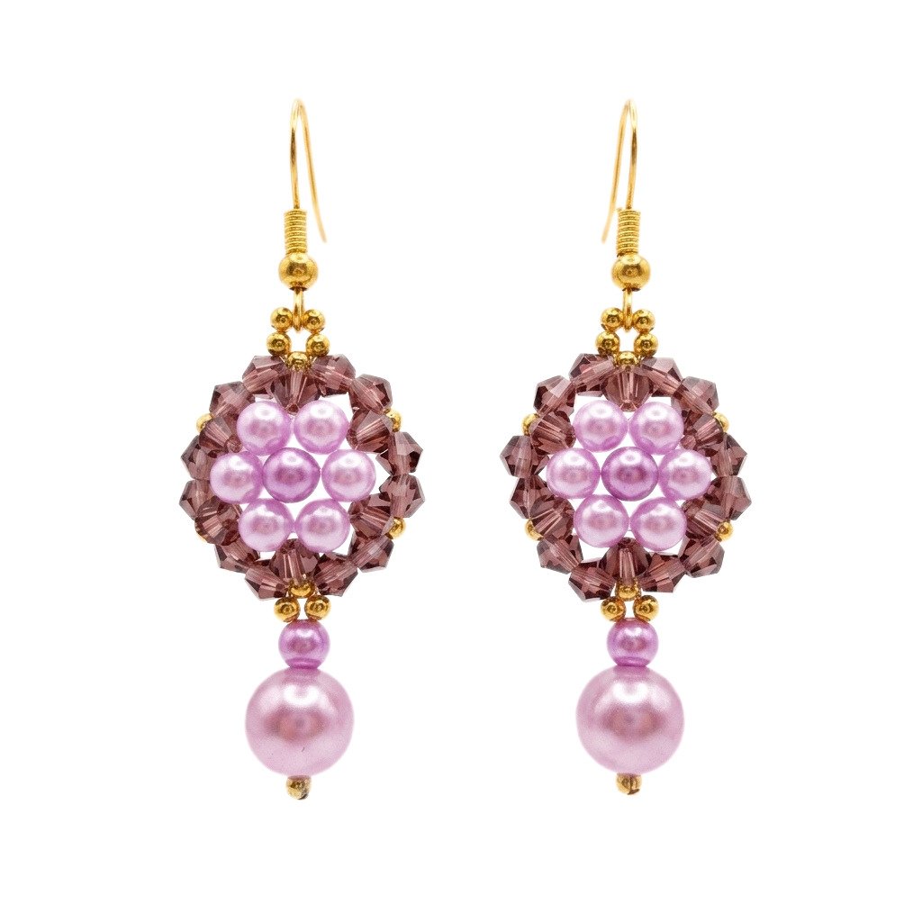 Pair of elegant purple pearl and crystal earrings with luminous lavender pearls, faceted plum-purple crystals, gold-coloured accents and dangling pearl drops on a white background.