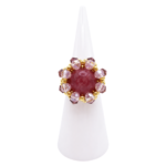 Handmade purple tourmaline ring with pink and purple crystals and gold-tone beads on a white ring display cone, shown against a white background.