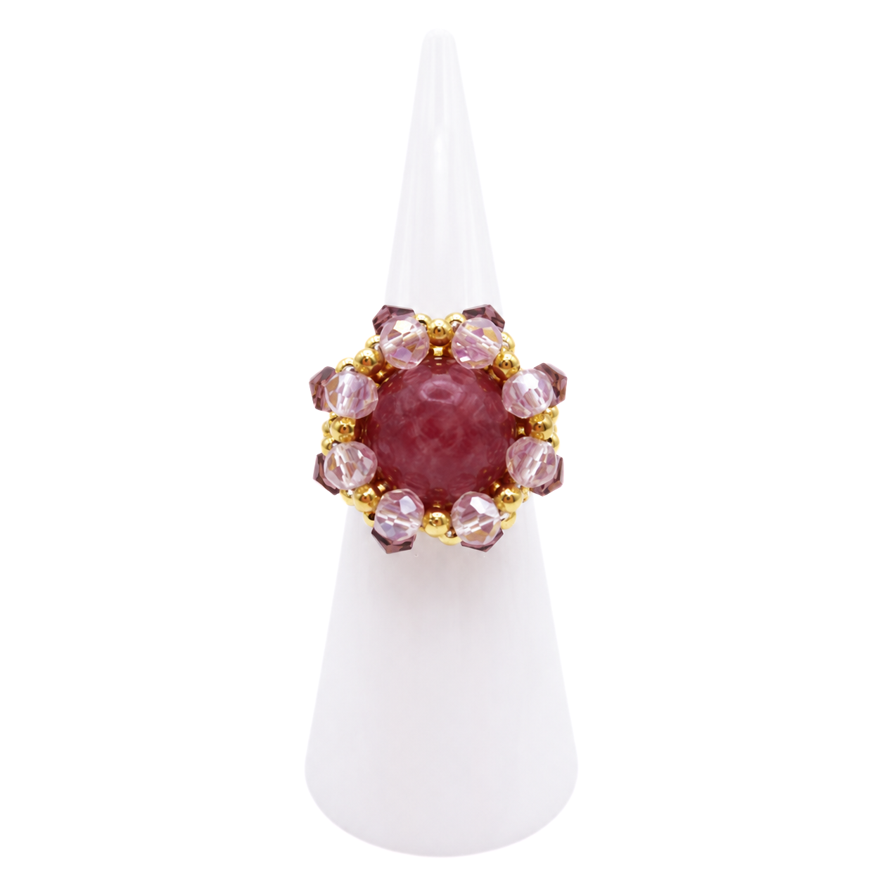 Handmade purple tourmaline ring with pink and purple crystals and gold-tone beads on a white ring display cone, shown against a white background.