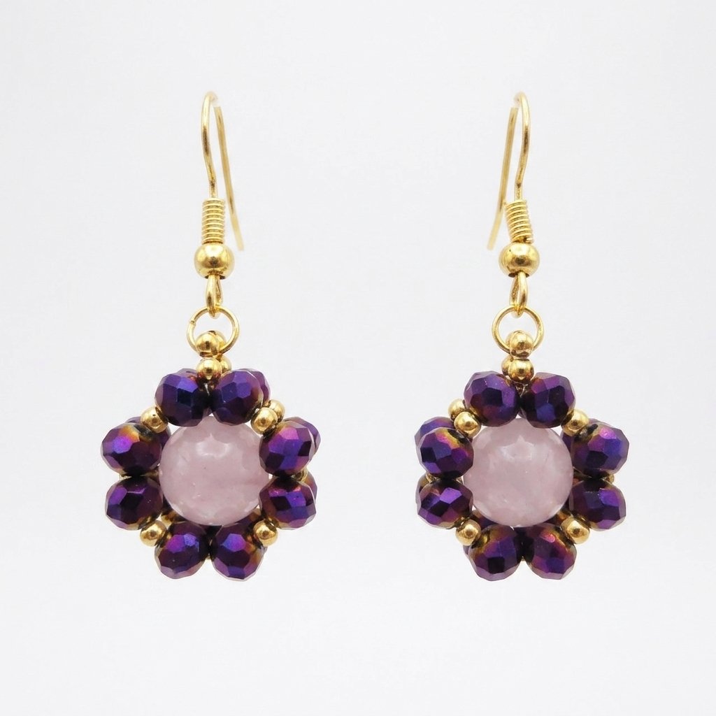 rose-quartz-crystal-earrings Rose quartz flower earrings with metallic purple crystal beads and gold-tone hooks, shown against a neutral background.