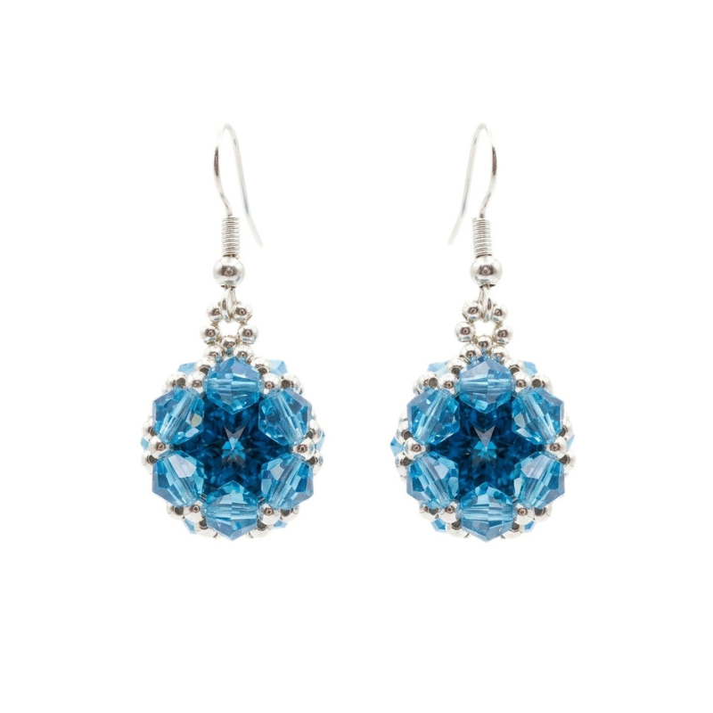 Handmade beaded earrings featuring faceted aquamarine crystals surrounding a sapphire blue centre stone. Shown against a white background.