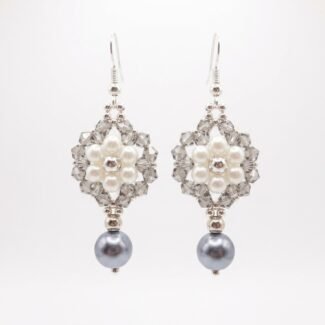 Pair of elegant silver pearl and crystal earrings with soft ivory pearls, faceted silver-grey crystals, silver-coloured accents and dangling grey pearl drops on a white background.