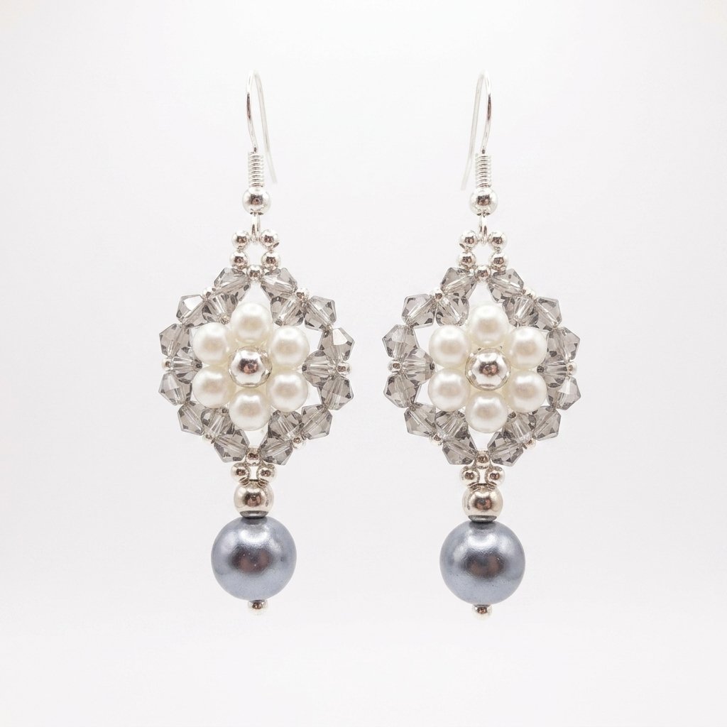silver-grey-pearls-crystal-drop-earrings Pair of elegant silver pearl and crystal earrings with soft ivory pearls, faceted silver-grey crystals, silver-coloured accents and dangling grey pearl drops on a white background.