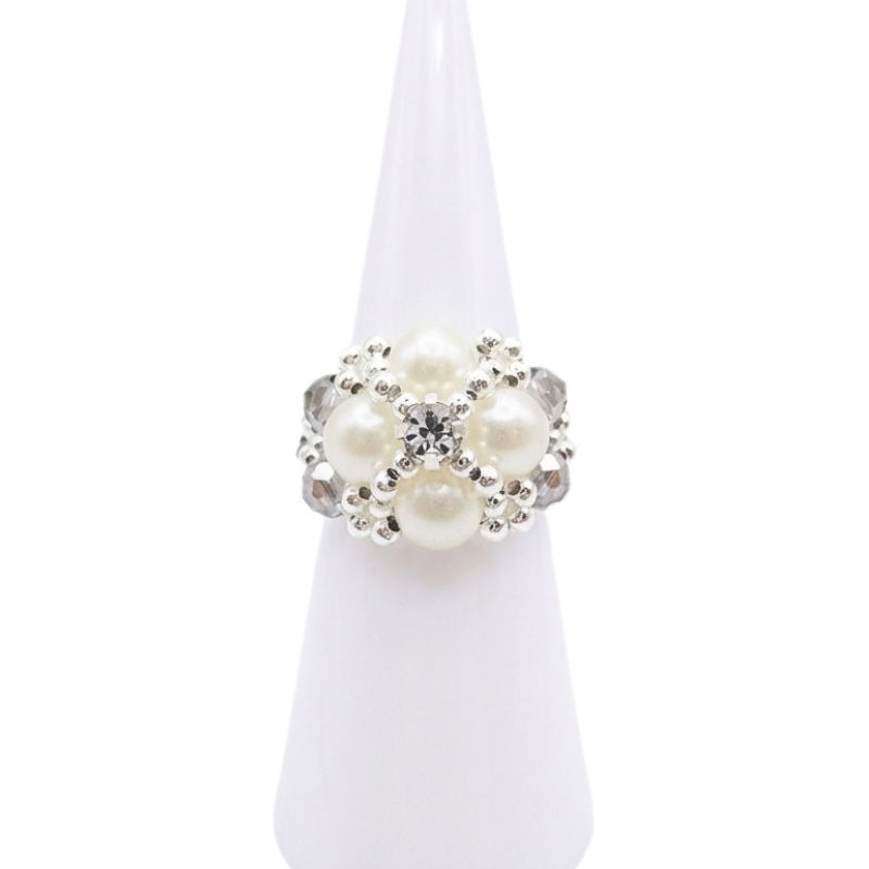 Handmade statement ring featuring faux pearls, grey crystal beads, and a center rhinestone, shown against a white background