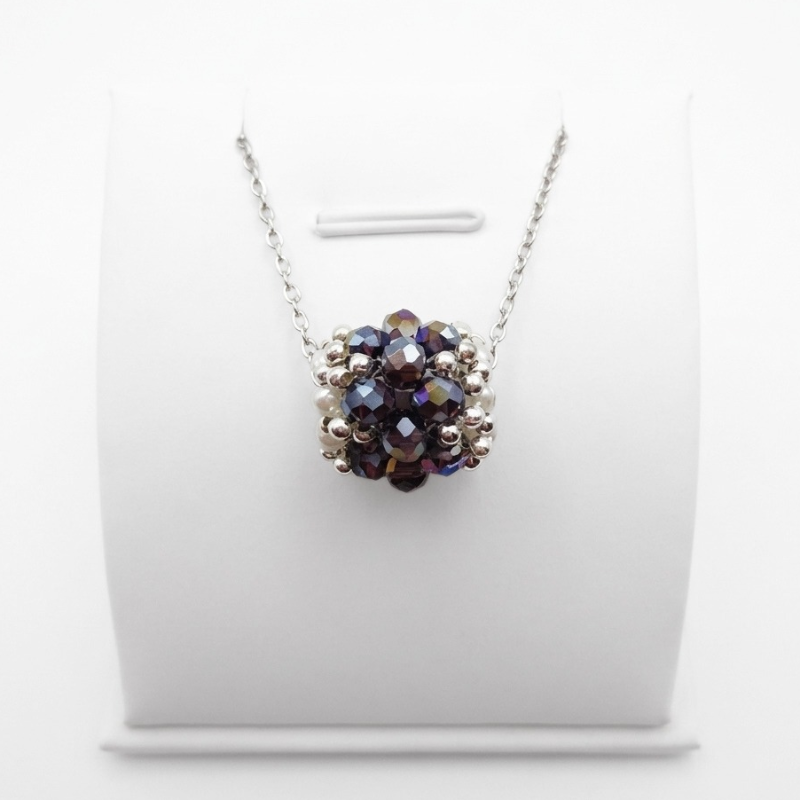 barrel-crystal-pendant-amethyst Handmade barrel-shaped amethyst AB crystal pendant necklace with white pearls and silver-tone beads on a silver chain, displayed on a white jewellery stand