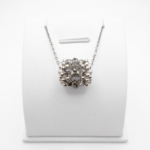 Handmade barrel-shaped silver-grey crystal pendant necklace with white pearls and silver-tone beads on a silver chain, displayed on a white jewellery stand